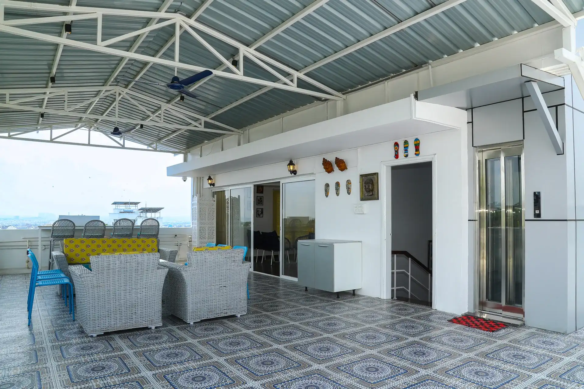 The covered rooftop terrace with seating beneath a pitched roof
