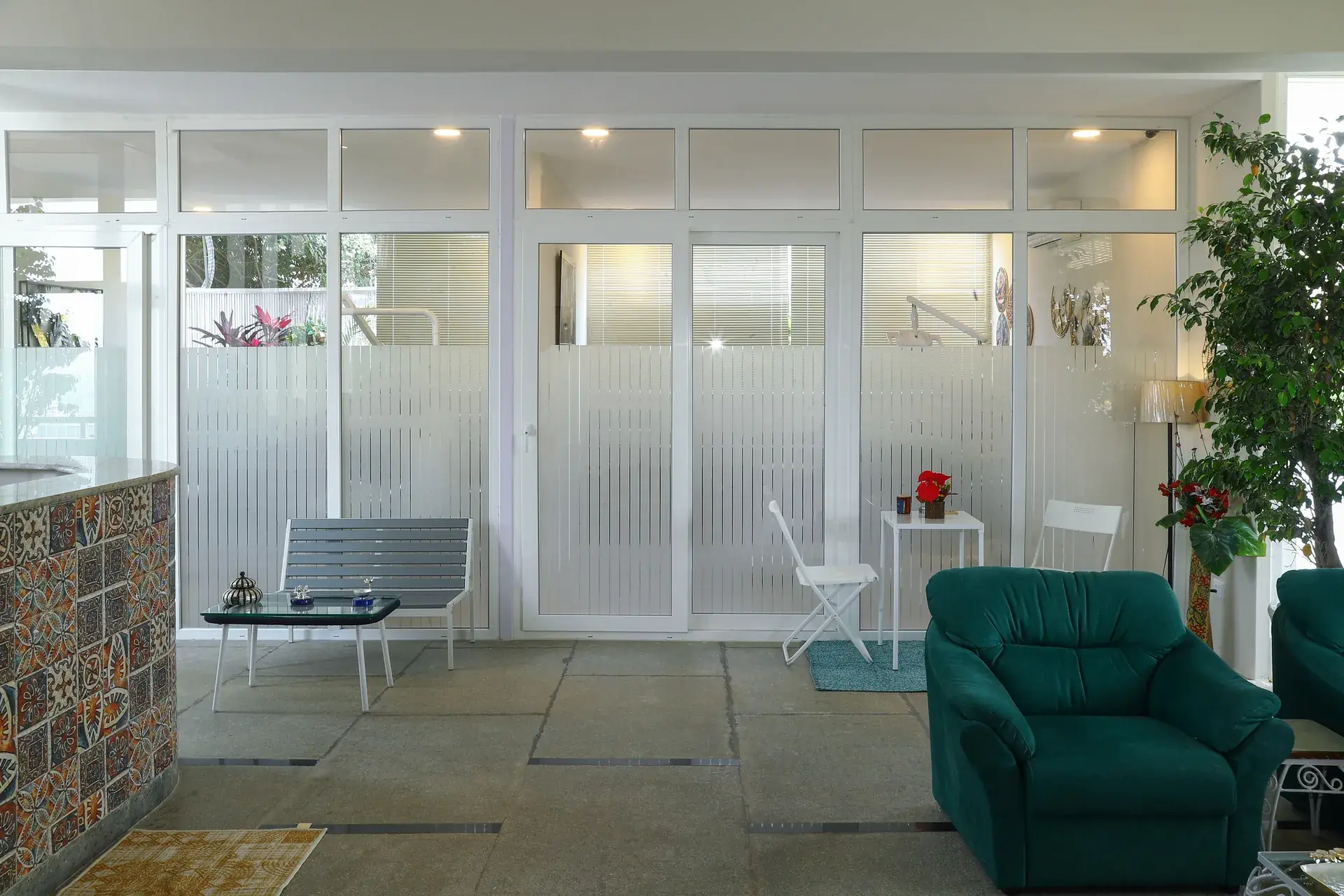 The waiting area with a bench, armchair and exposed brick wall