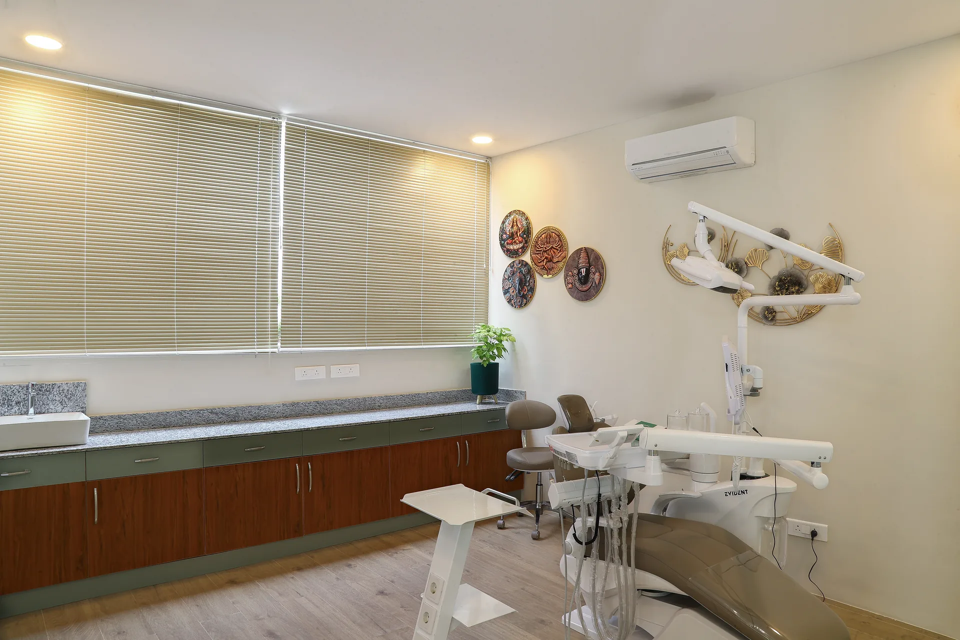 A treatment room with a dental chair beside a shuttered window