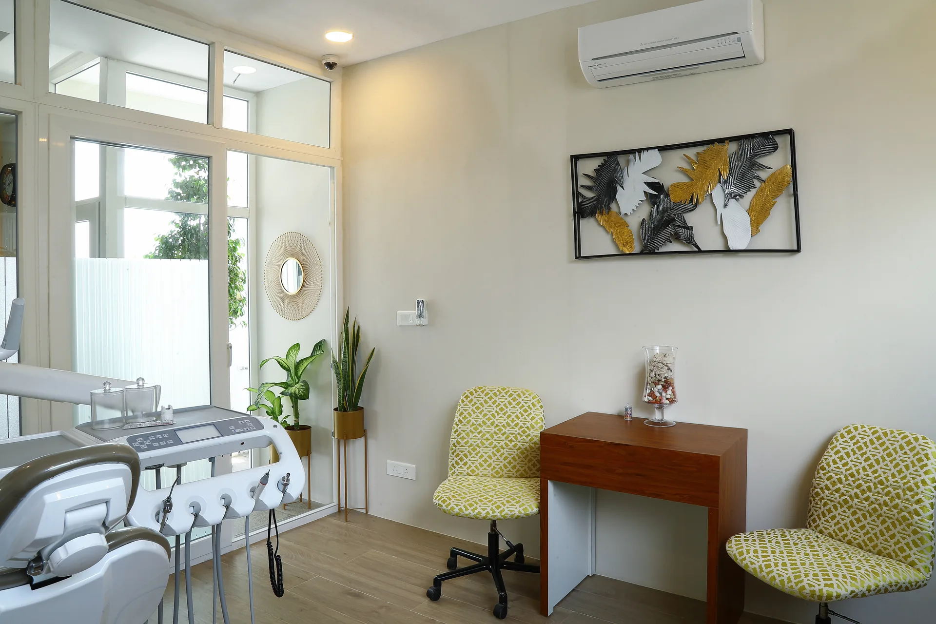 A consultation room with a dental unit beside the desk