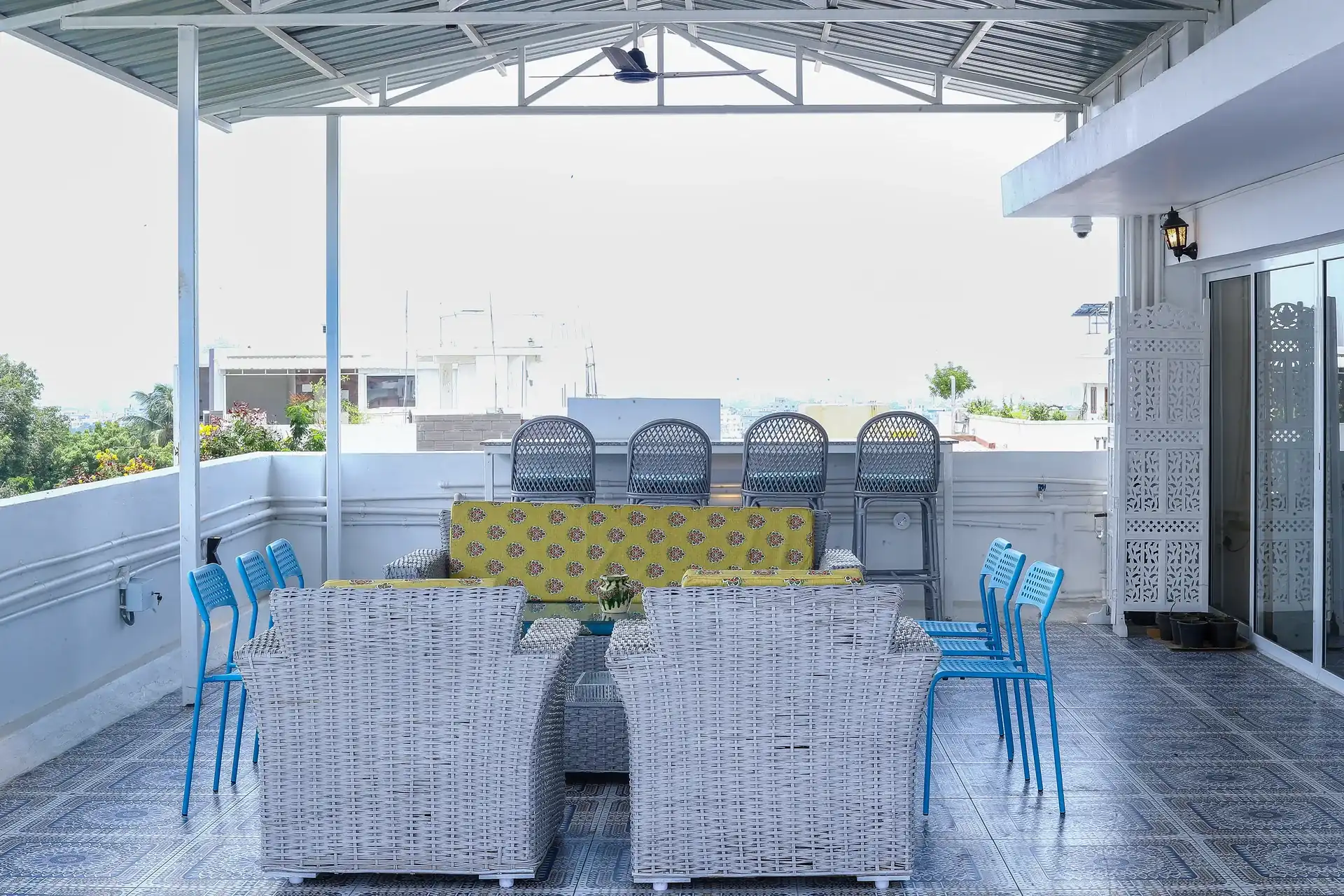 The rooftop terrace with covered seating and a view across the city
