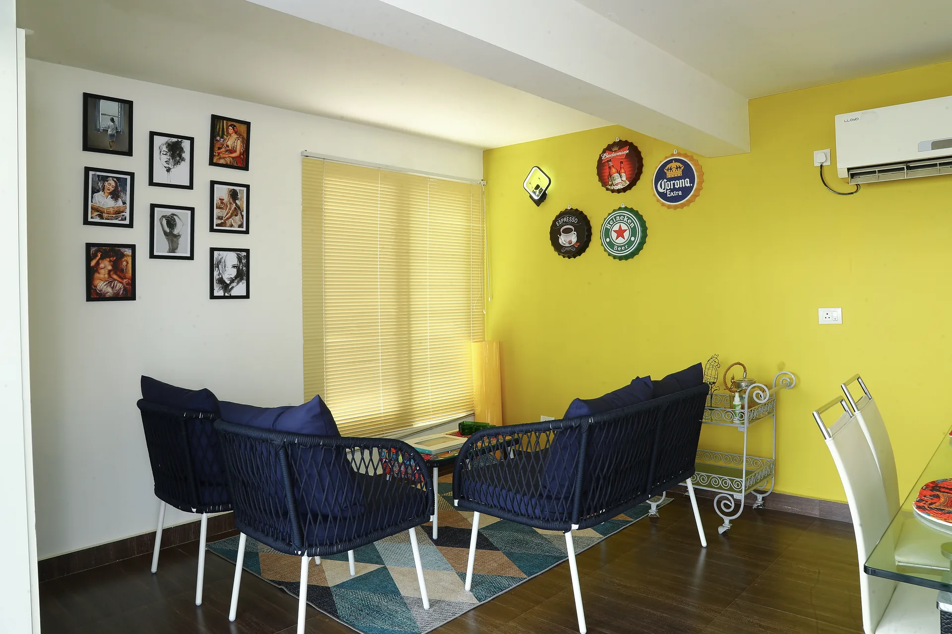 A lounge with blue chairs against a yellow accent wall