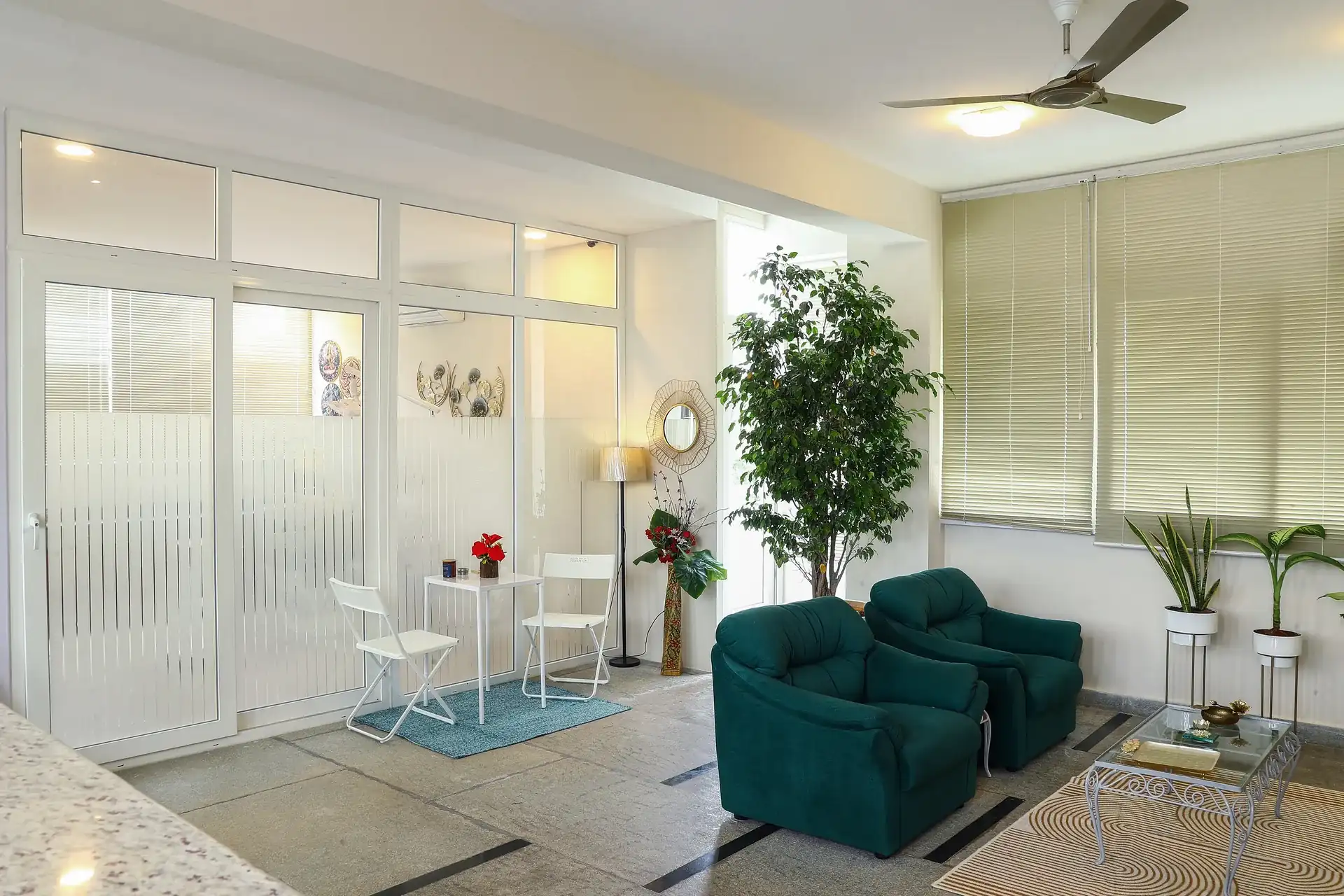 A wider view of the lounge, with glass partitions leading through to the treatment rooms